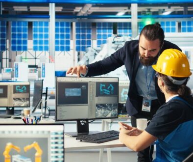 Solar panel plant manager showing engineer how to develop prototypes